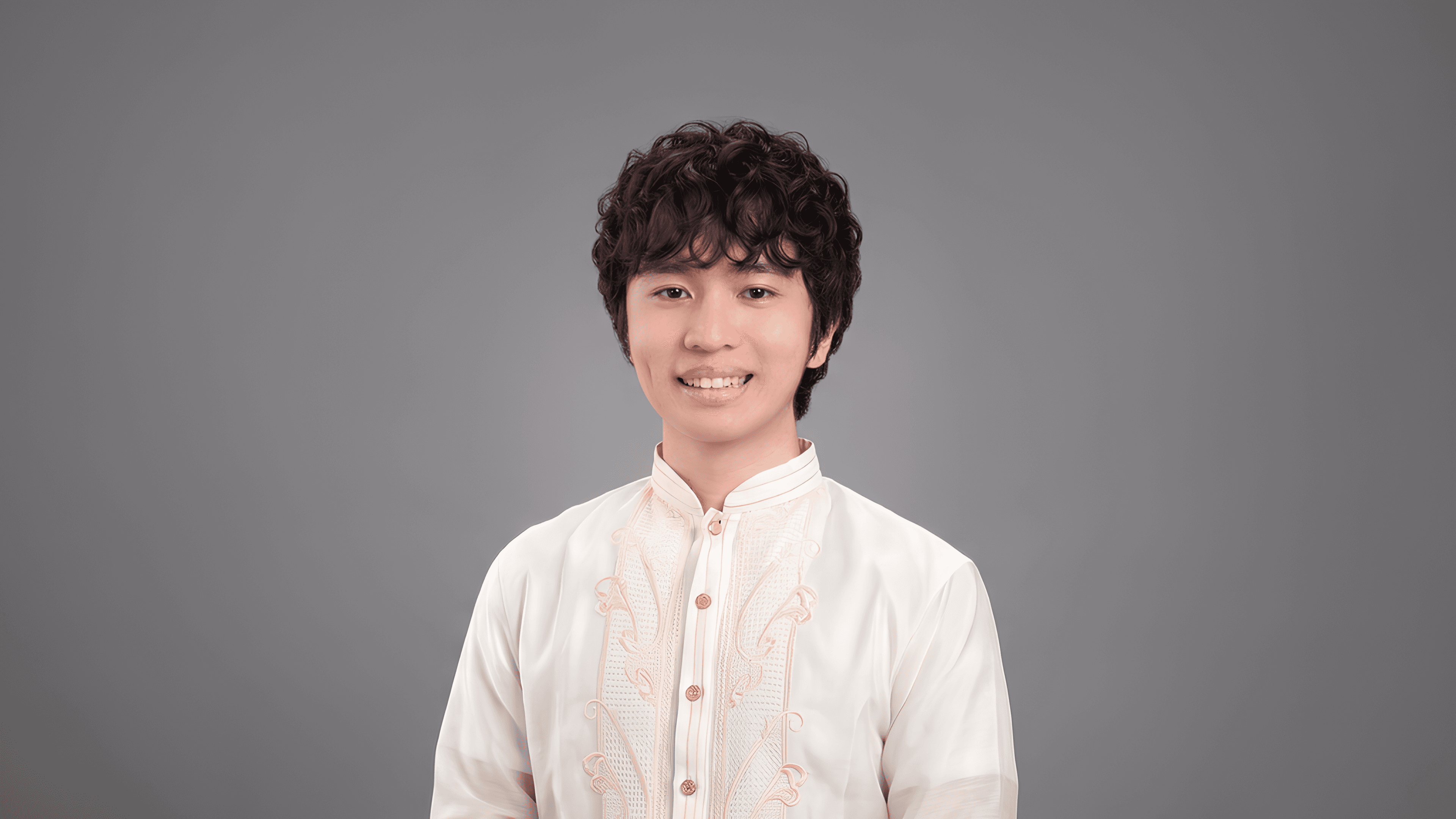 Nathanael Larida wearing a cream barong in a studio portrait